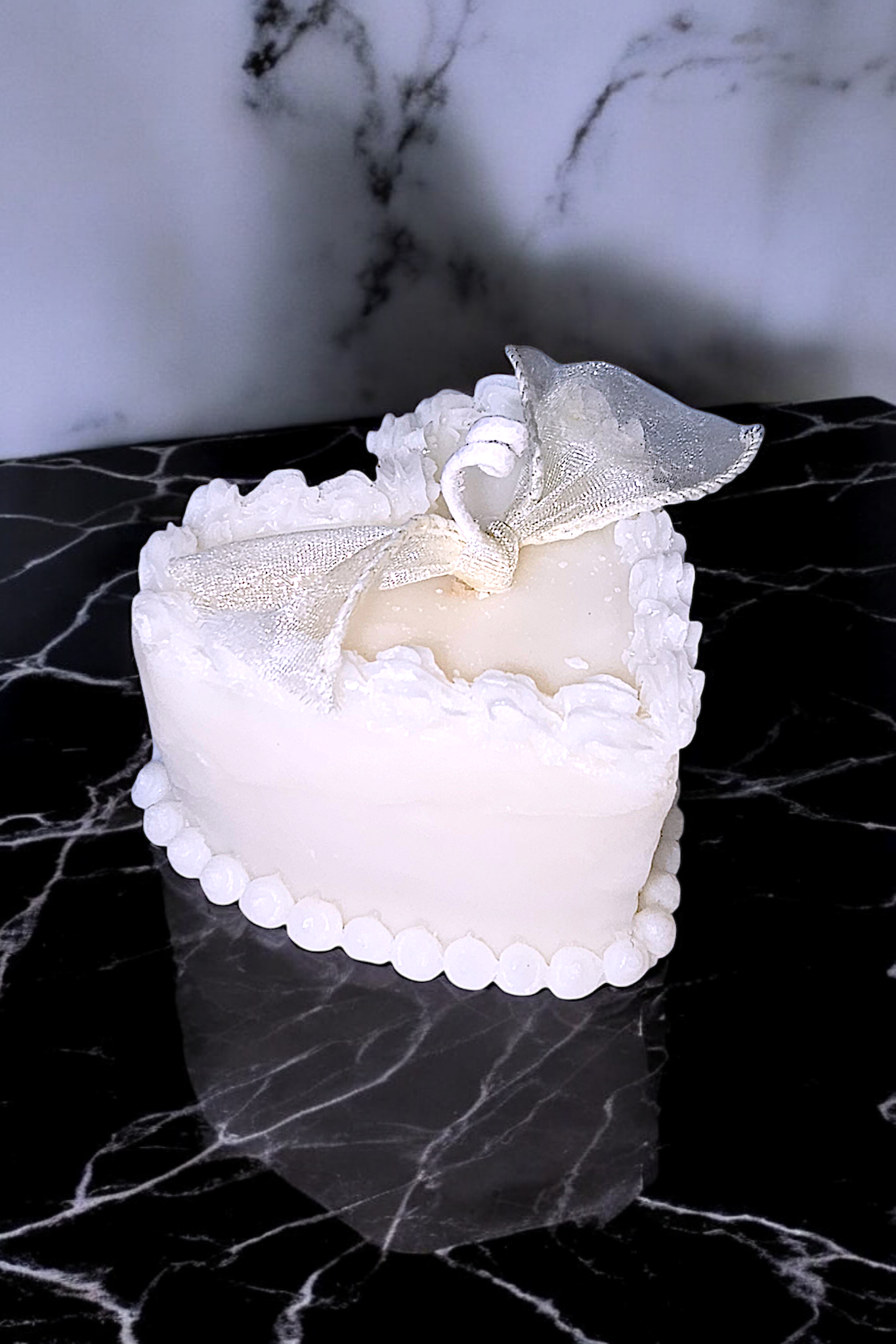 Closeup of Buttercream Amour Candle – intricate buttercream trim details.
