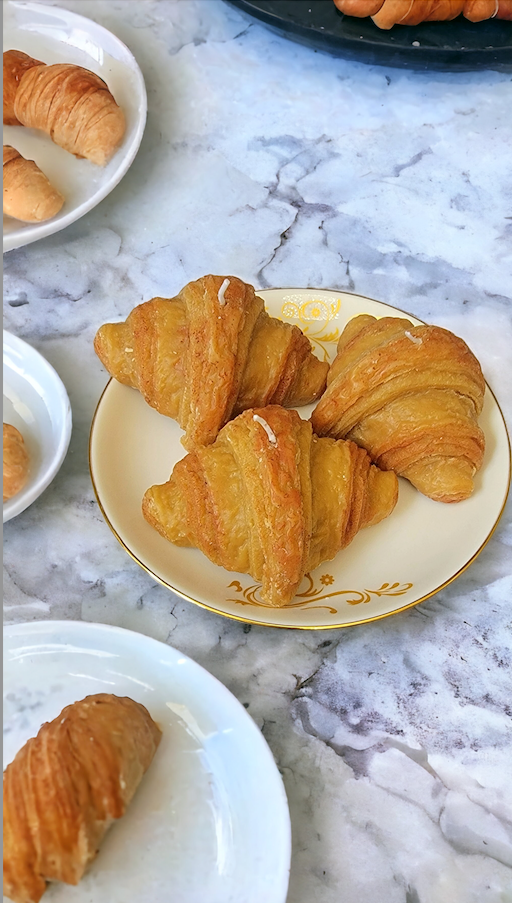 Golden Butter Croissant Candle styled on kitchen counter – Parisian decor.