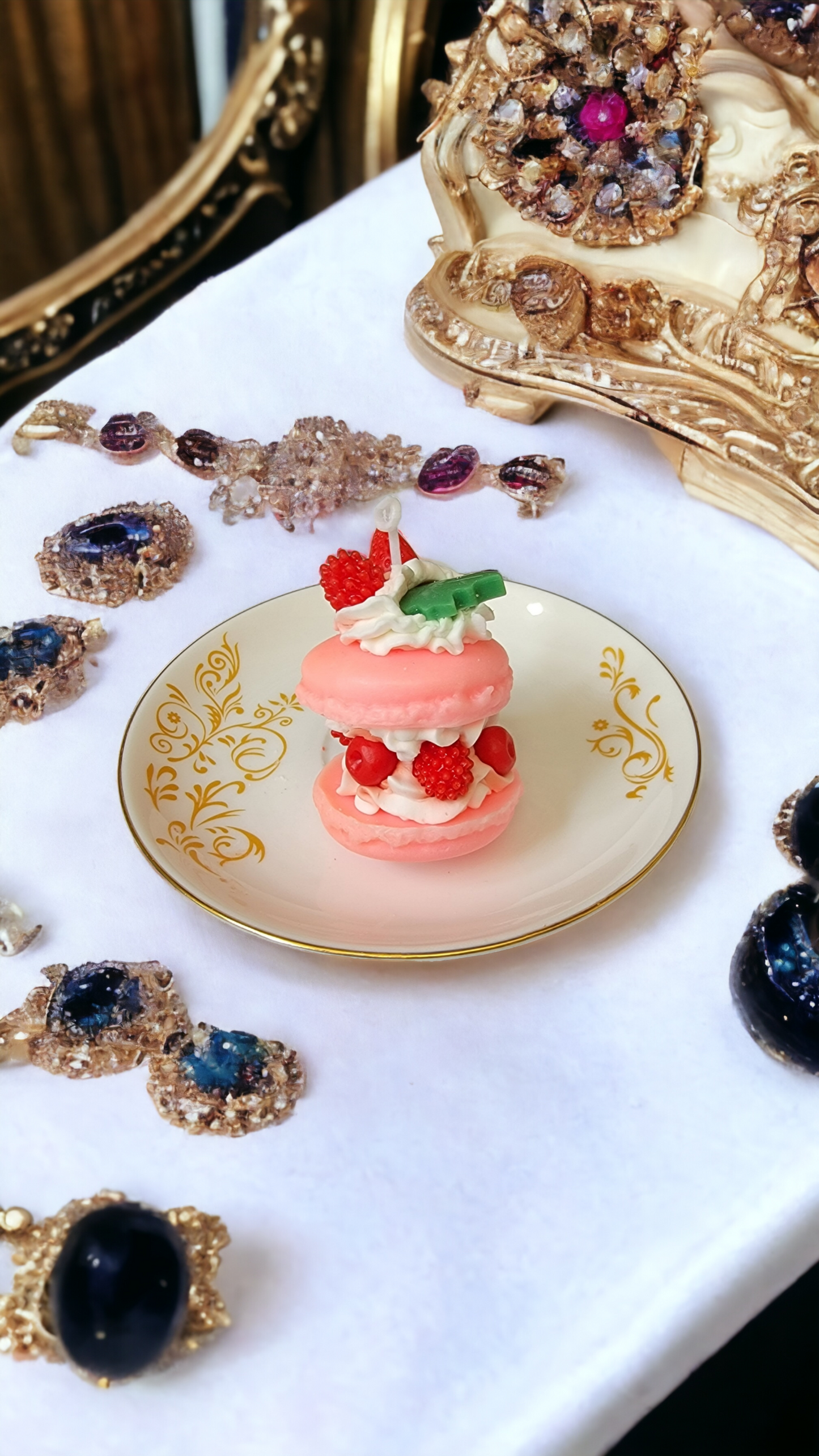 Closeup of stuffed macaron candles with berry and leaf garnish – realistic dessert candle.
