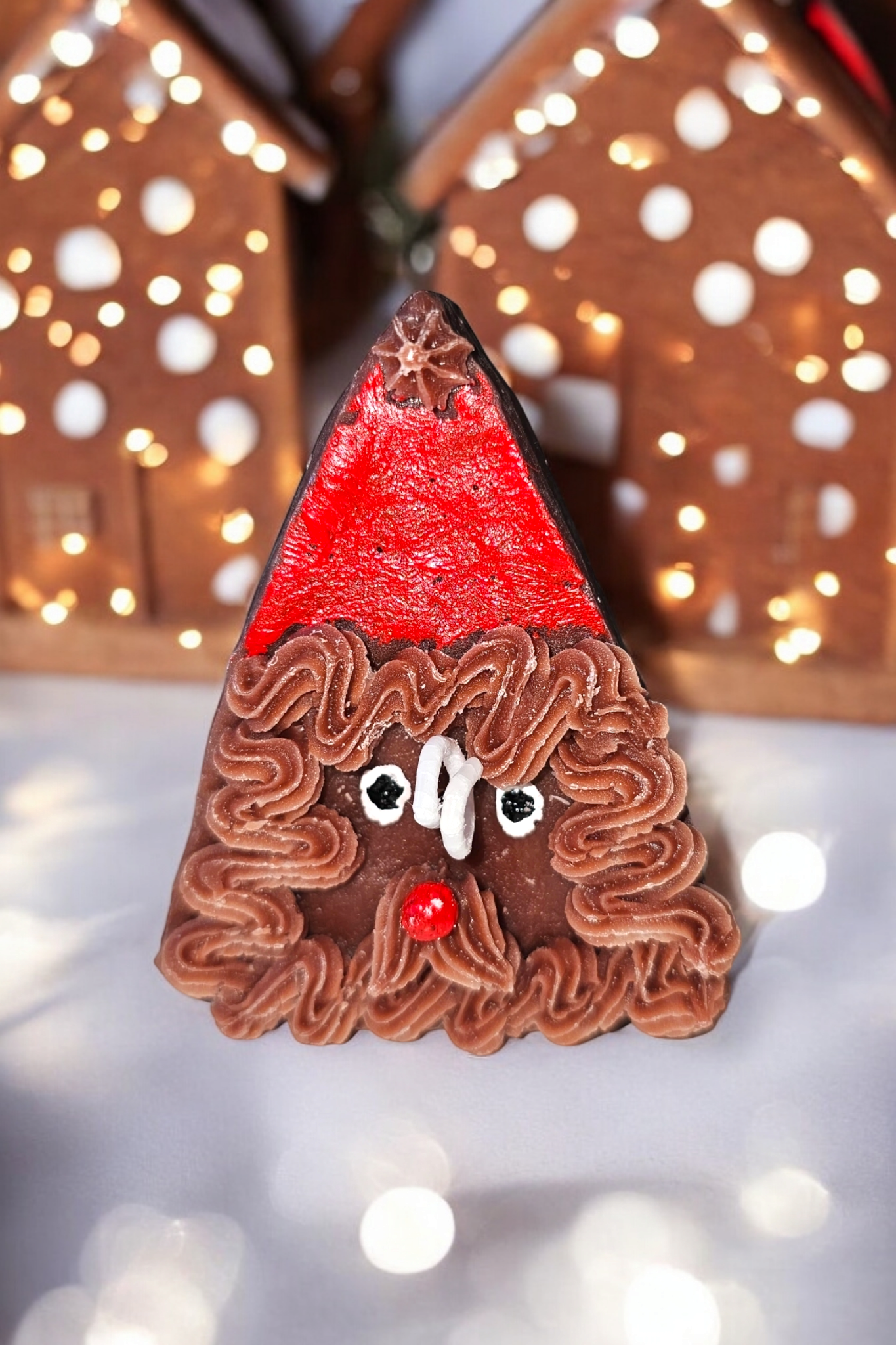 Closeup of Santa Cookie Candle – handmade Christmas dessert candle with piped Santa face